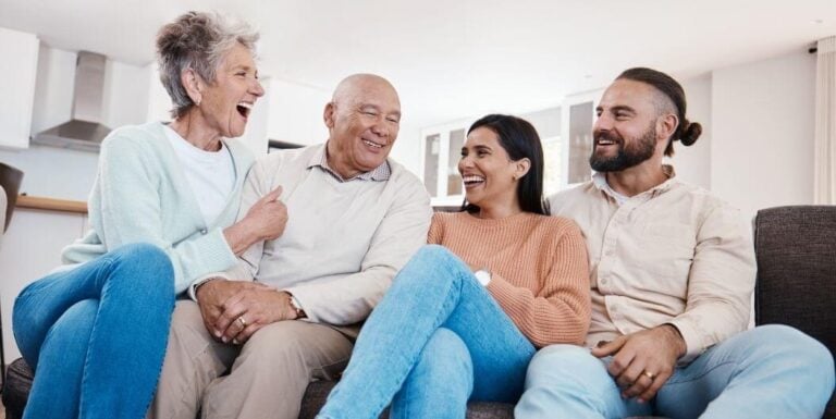 Happy Senior Couple Bonding with Their Couple Children in an Assisted Living Facility