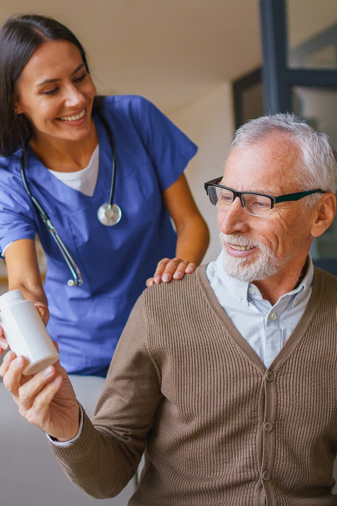 Nurse Comforting Elderly Woman at Nursing Home Oxford